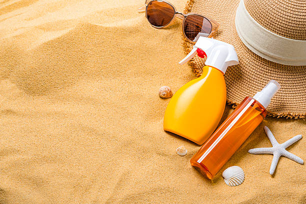 Protective suntan cream bottles on the beach sand