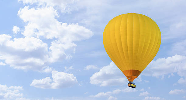 istock Cloudy sky with yellow balloons. Banner. Space for text on the left 2216657314