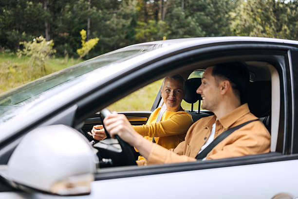 istock Casually clothed couple riding in car together 2216657457