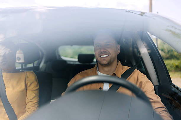 istock Casually clothed couple riding in car together 2216657459