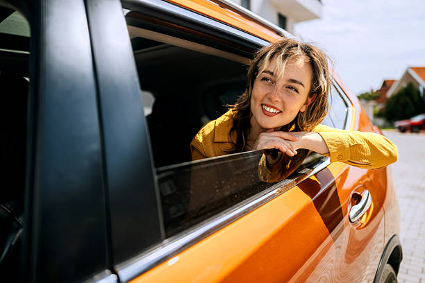 istock Woman enjoying breeze while riding in back seat 2216657536