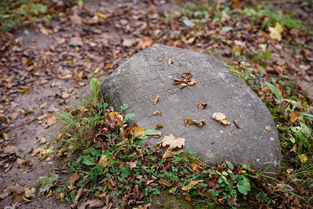 istock An ancient gravestone with Hebrew text carved into it. 2216659158