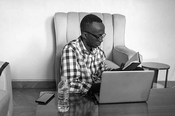 istock Focused Man Reading and Working on Laptop 2216659861