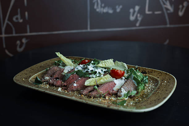 istock Useful tasty beef with cherry tomatoes, grated cheese with lettuce and greens. Original beautiful serving snack 2216663674