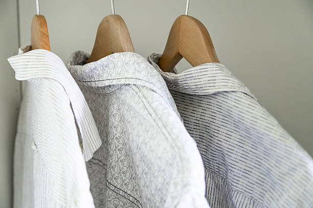 Three shirts on hangers hanging in the closet