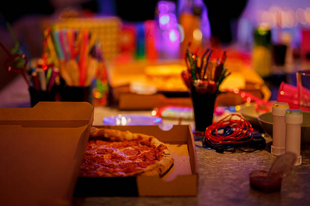 An inviting table setting showcasing a freshly baked pizza alongside an array of artistic and craft supplies, creating a casual yet lively scene ideal for social and creative occasions.