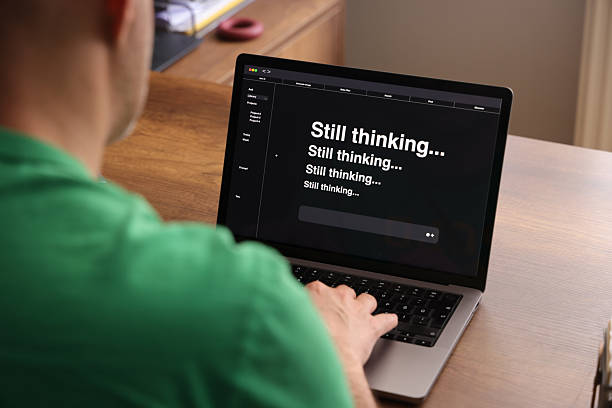 istock Frustrated Man Waiting for AI Response on Laptop Screen 2216665090