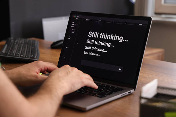 istock Frustrated Man Waiting for AI Response on Laptop Screen 2216665174