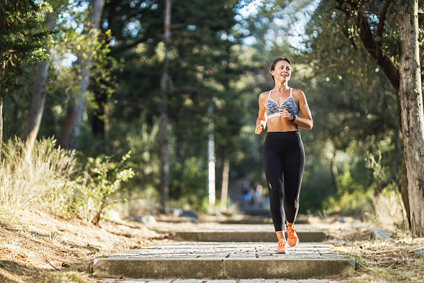 istock Woman Running In Park At Summer Day 2216672413