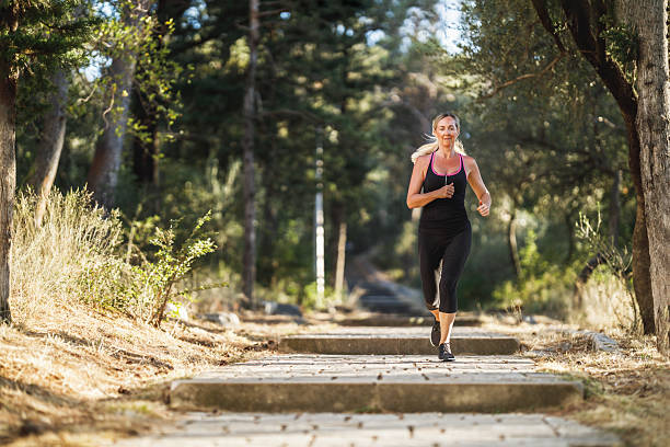 istock Woman Running In Park At Summer Day 2216672434