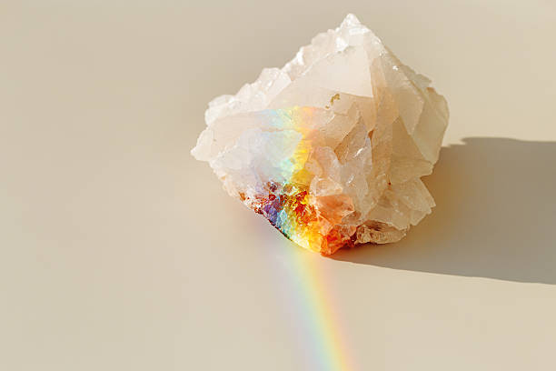 istock Luminous Quartz with Rainbow Flares. Sun's rays interact with quartz stone, iridescent rainbow glares, background with shining crystal at sunlight, aesthetic view with natural light effect 2216674076