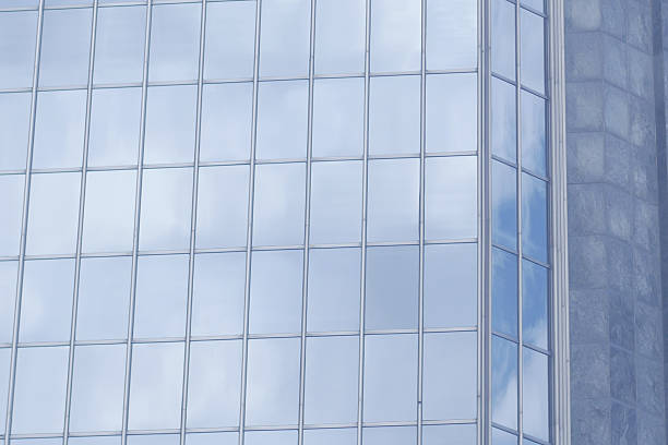 istock Reflective glass surfaces showing clouds in urban setting 2216675365