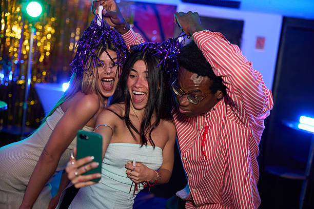 istock Friends taking a selfie at a lively party 2216676119