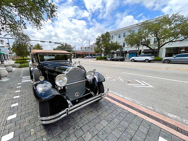 Coral Gables, Miami, Florida, United States of America - May 3, 2025: Beautifully restored vintage Packard automobile is parked on the Miracle Mile shopping street in Coral Gables, Florida, showcasing a glimpse into the city's rich history and automotive heritage