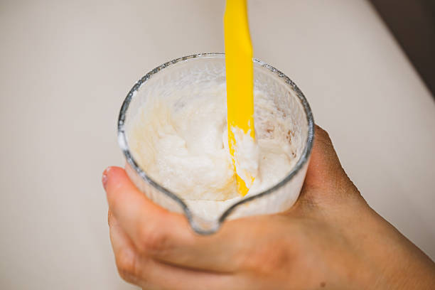 istock Pouring Cream into a Glass Cup 2216683678