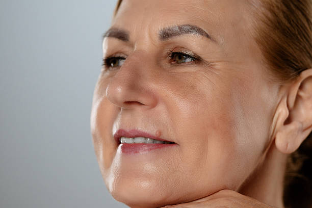 istock Thoughtful Mature Woman with Hand on Face Close Up 2216686972