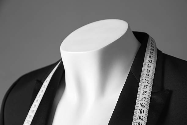 istock Mannequin with black jacket and measuring tape on grey background, closeup 2216689124