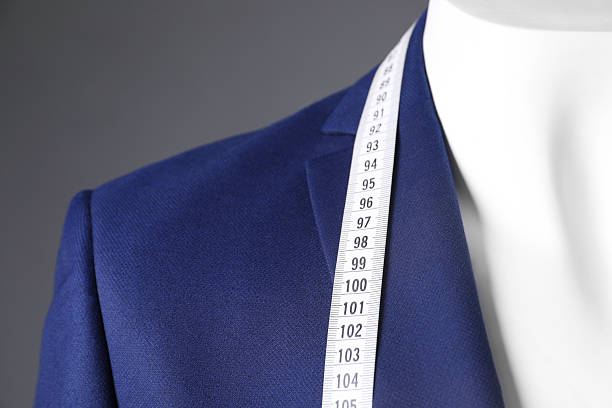 istock Mannequin with blue jacket and measuring tape on grey background, closeup 2216689147