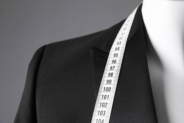 istock Mannequin with black jacket and measuring tape on grey background, closeup 2216689161
