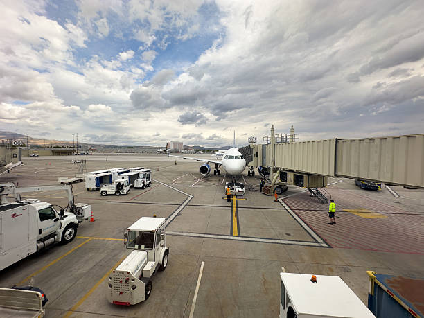 23 MAY 2025 - Reno, USA - A plane and ground crew loading with a skybridge at Reno airport USA
