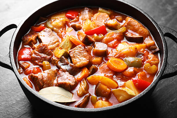 istock Delicious stew with vegetables in pot on gray textured table, closeup 2216689592