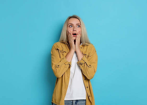 istock Portrait of scared woman on light blue background, space for text 2216691954