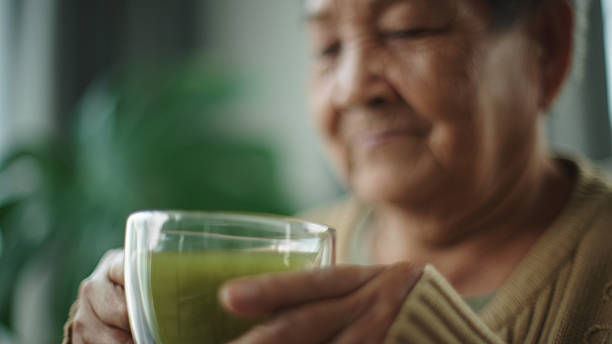 istock Senior woman drinking matcha hot drink. 2216692533