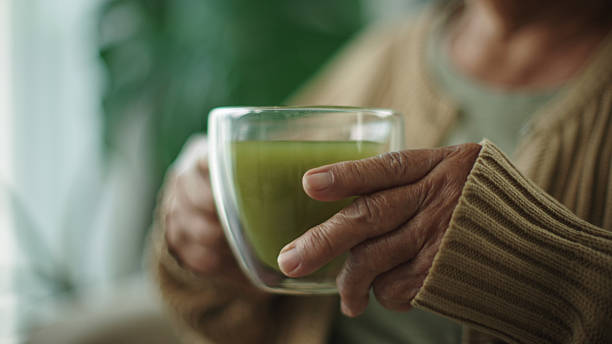 istock Senior woman drinking matcha hot drink. 2216692536