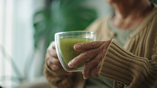 istock Senior woman drinking matcha hot drink. 2216692561