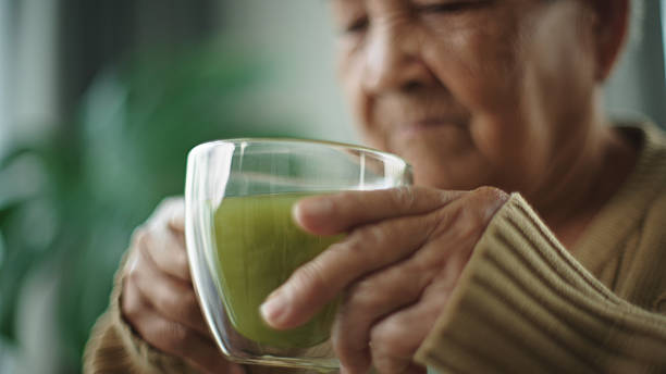 istock Senior woman drinking matcha hot drink. 2216692590