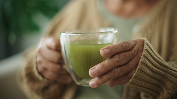 istock Senior woman drinking matcha hot drink. 2216692598