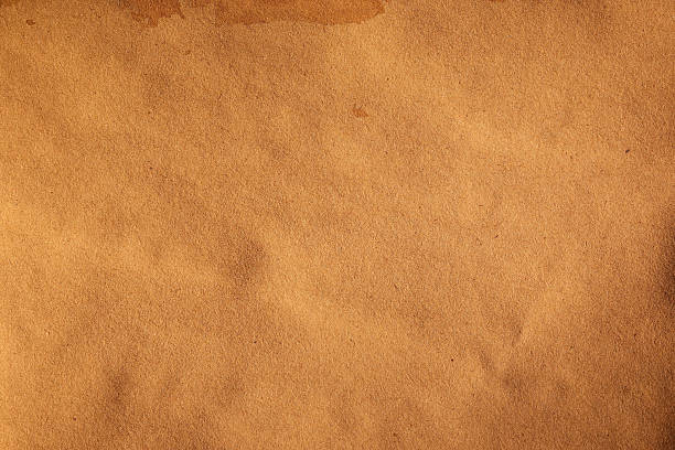 istock Crumpled Kraft backgrounds paper with brown stains 2216692916