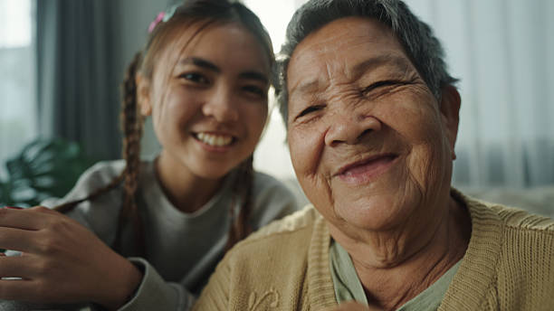 istock POV a smartphone in use by a elderly and teenager. 2216693521