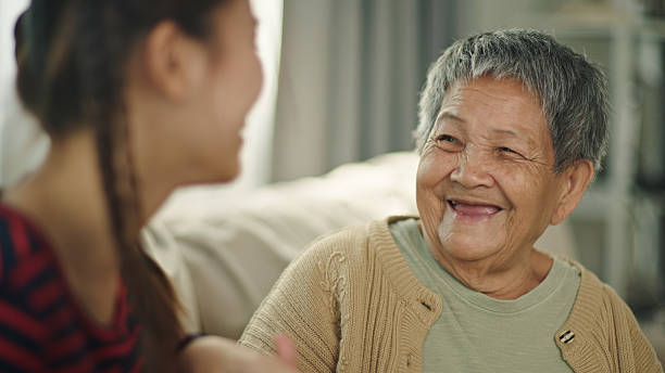 istock Elderly relax talking with granddaughter on sofa. 2216694378