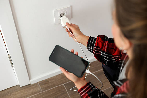 istock Woman charging her mobile phone 2216694518