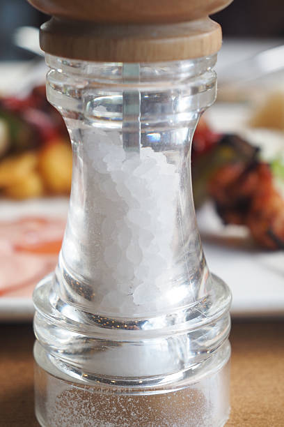 istock Close-up of a salt grinder next to a gourmet meal setting 2216696151