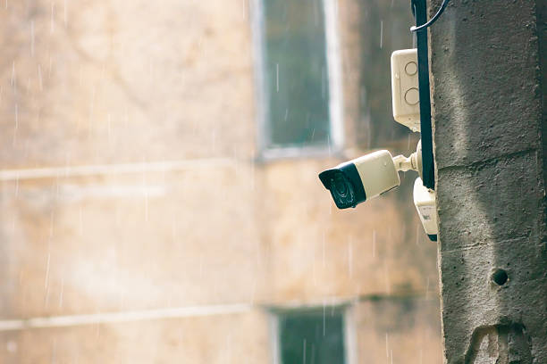istock Surveillance Camera Mounted on Wall in Rainy Weather 2216702940