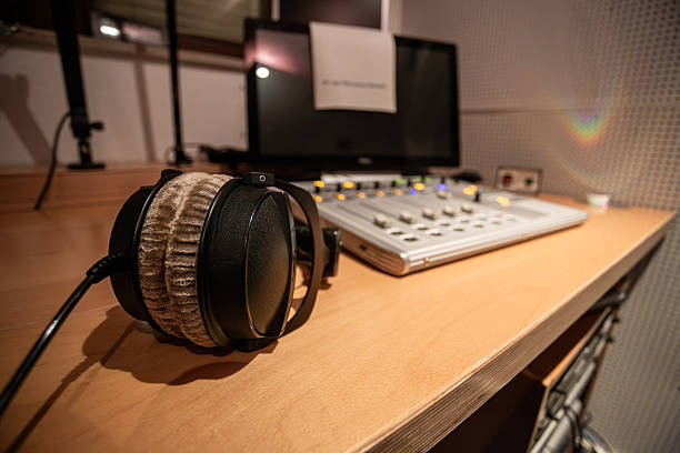 istock Recording studio setup with headphones and sound mixing equipment during evening hours 2216704414