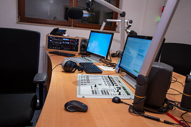istock Broadcast studio featuring modern equipment with computers, microphones, and sound controls positioned for live programming 2216704494