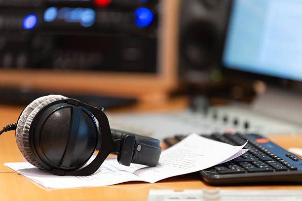 Shot of man's hand operating with sound recording studio mixer.