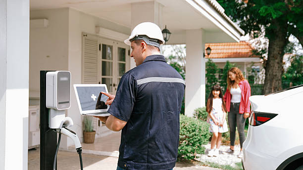 istock Qualified technician working with laptop for home EV station. Synchronos 2216705122