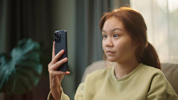 istock Teenager unlocking smartphone with face recognition. 2216710082