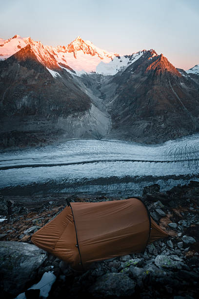 istock Tent at campsite on mountain peak above glacier 2216710488