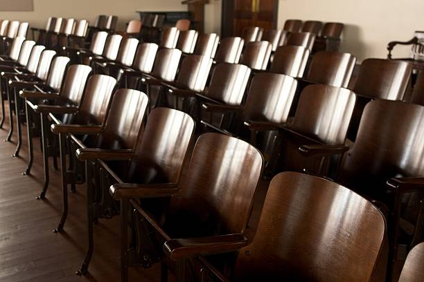 istock Vintage wood row seating in old school auditorium 2216713488