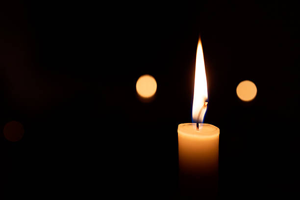 istock A candle is lit in a dark room 2216716647