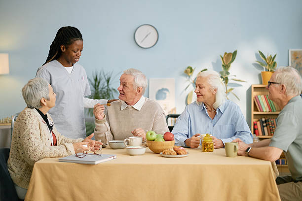 istock Healthcare Professional Interacting with Elderly Group 2216718714