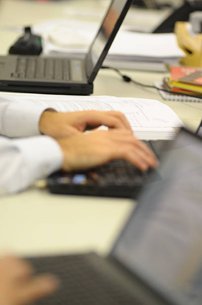 istock Hand Typing on Laptop in a Row on Table, Selective Focus with Blurred Background 2216720578