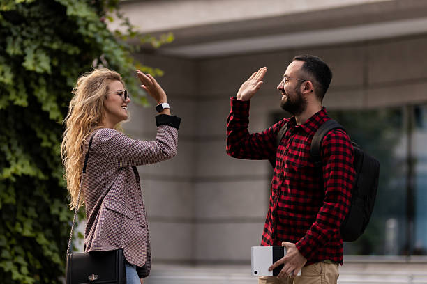 istock Friendly encounter between two colleagues sharing a high five outdoors 2216720967