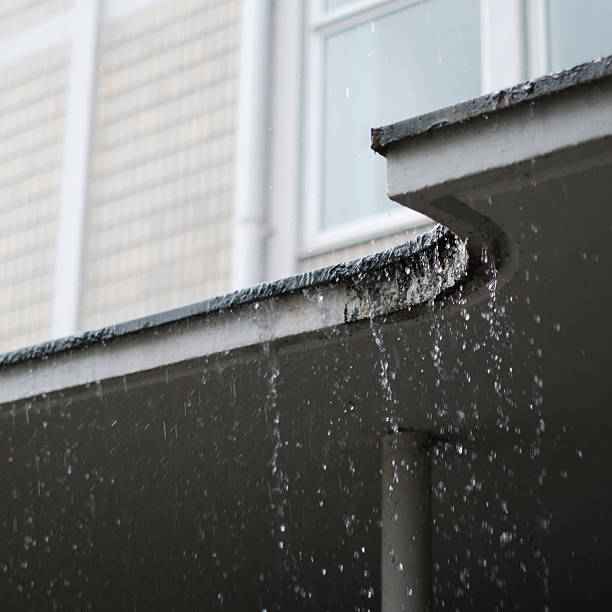 istock Close-up of heavy rain pouring down a roof 2216721370