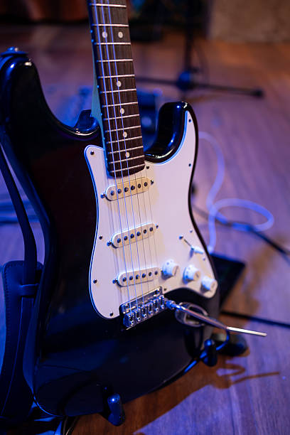 istock White and black electric guitar on its stand 2216721506